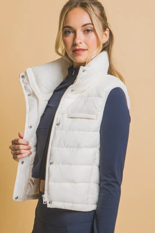 Optimize the title by adding descriptive and appealing modifiers for potential customers:

Stylish Kaelyn High Neck Zip-Up Puffer Vest with Convenient Storage Pouch