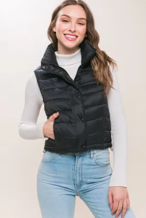 Optimize the title by adding descriptive and appealing modifiers for potential customers:

Stylish Kaelyn High Neck Zip-Up Puffer Vest with Convenient Storage Pouch